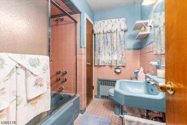 267 William St, Belleville Twp, NJ 07109 - bathroom with radiator, combined bath / shower with glass door, tile walls, and a wainscoted wall