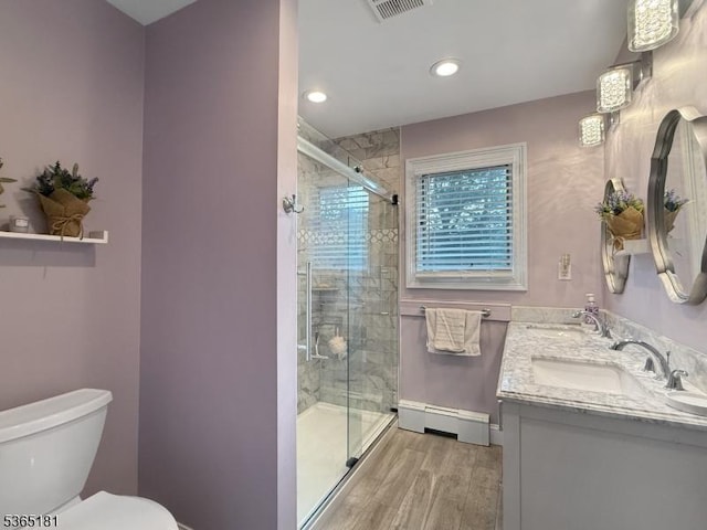 26 Knollwood Rd, Hanover Twp, NJ 07981 - full bath with baseboard heating, wood finished floors, double vanity, a shower stall, and recessed lighting