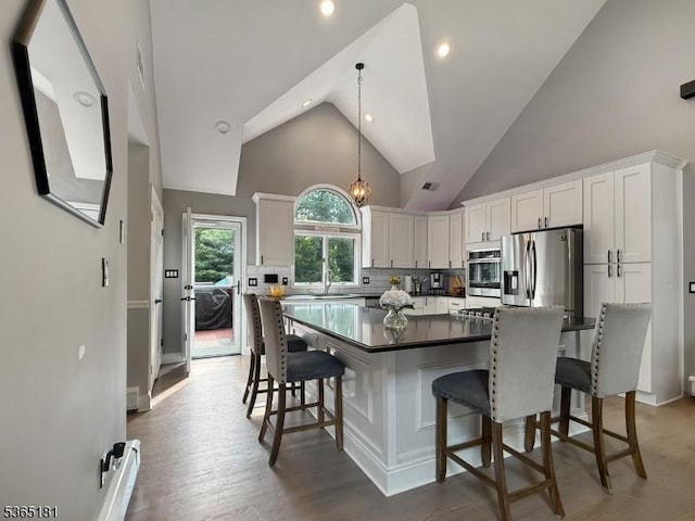 26 Knollwood Rd, Hanover Twp, NJ 07981 - kitchen with stainless steel appliances, a kitchen bar, backsplash, white cabinetry, and a spacious island