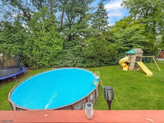 26 Knollwood Rd, Hanover Twp, NJ 07981 - view of pool featuring a trampoline, a lawn, and a playground