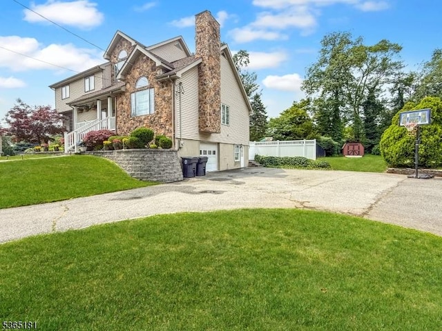26 Knollwood Rd, Hanover Twp, NJ 07981 - view of side of property featuring driveway, stone siding, a shed, an attached garage, and a chimney