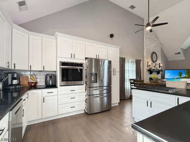 26 Knollwood Rd, Hanover Twp, NJ 07981 - kitchen with appliances with stainless steel finishes, high vaulted ceiling, dark countertops, ceiling fan, and white cabinetry
