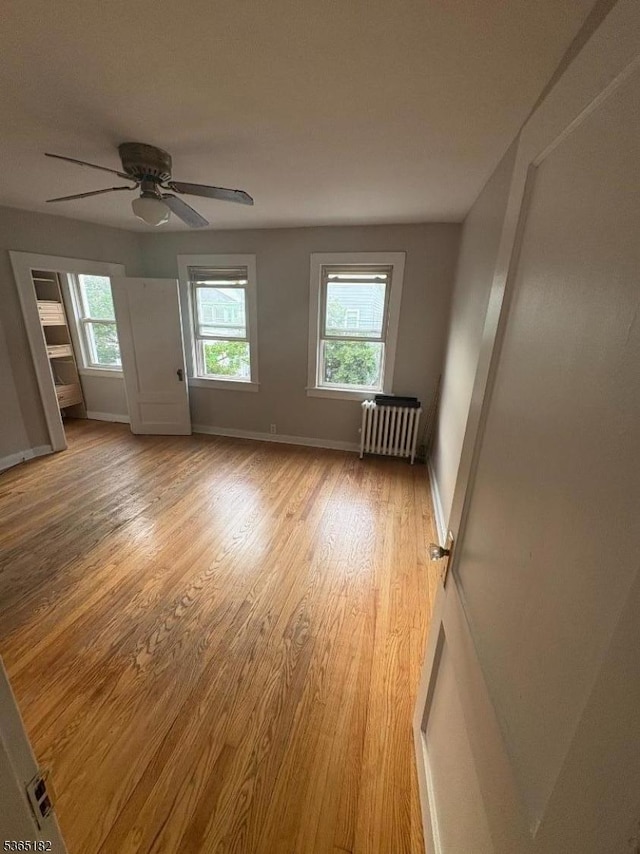 552 Liberty St, City Of Orange Twp, NJ 07050 - unfurnished room with radiator heating unit, light wood-style floors, and ceiling fan