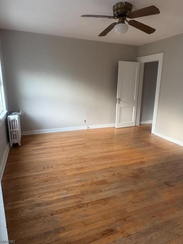 552 Liberty St, City Of Orange Twp, NJ 07050 - unfurnished room with radiator heating unit, wood finished floors, and a ceiling fan