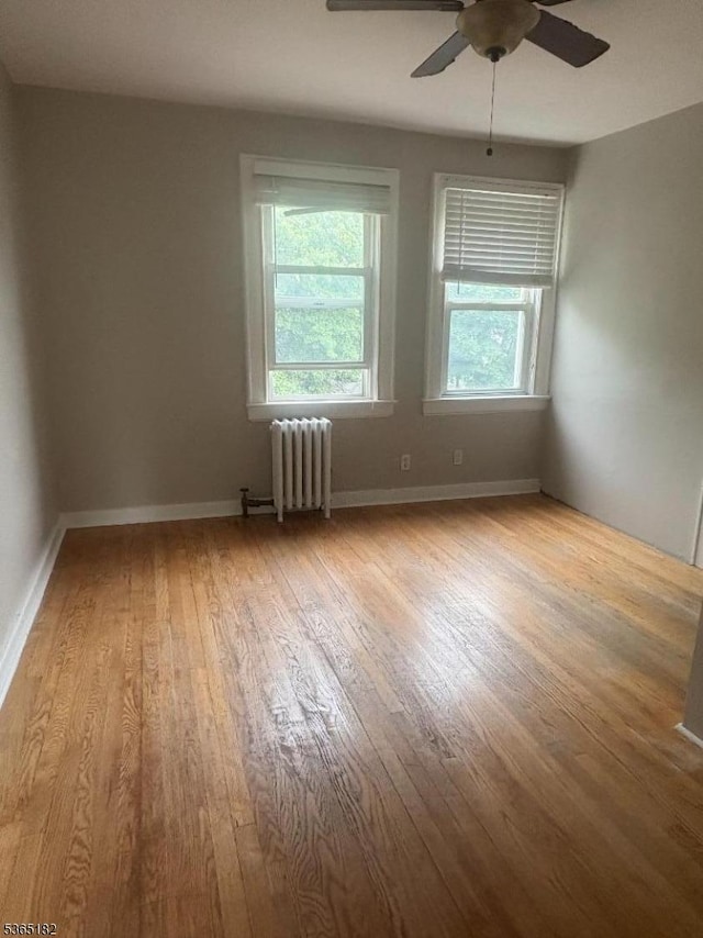 552 Liberty St, City Of Orange Twp, NJ 07050 - unfurnished room with radiator, wood finished floors, and a ceiling fan