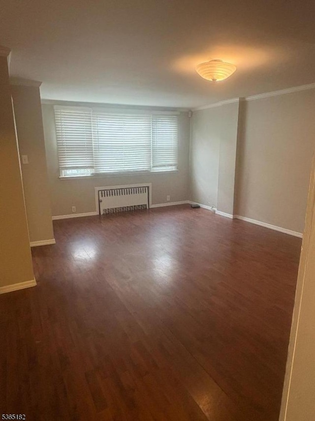 552 Liberty St, City Of Orange Twp, NJ 07050 - unfurnished living room with radiator heating unit, ornamental molding, and wood finished floors