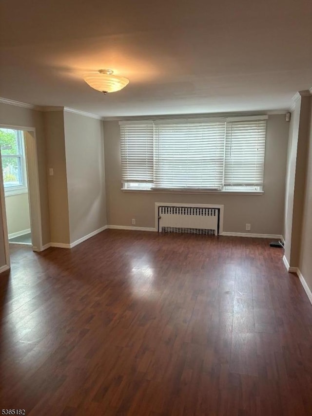 552 Liberty St, City Of Orange Twp, NJ 07050 - empty room with radiator, crown molding, and dark wood finished floors