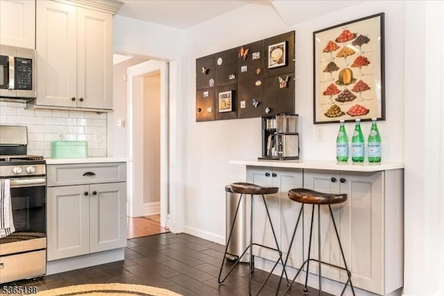35 Elm Ct, South Orange Village Twp, NJ 07079 - kitchen with stainless steel appliances, dark wood finished floors, light countertops, and tasteful backsplash