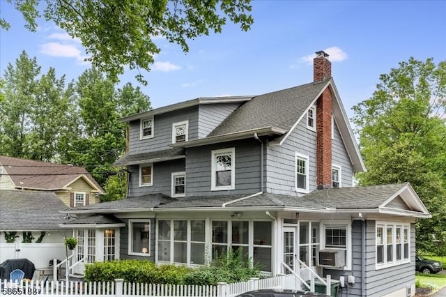 35 Elm Ct, South Orange Village Twp, NJ 07079 - view of front of house featuring a sunroom, a shingled roof, a chimney, and cooling unit
