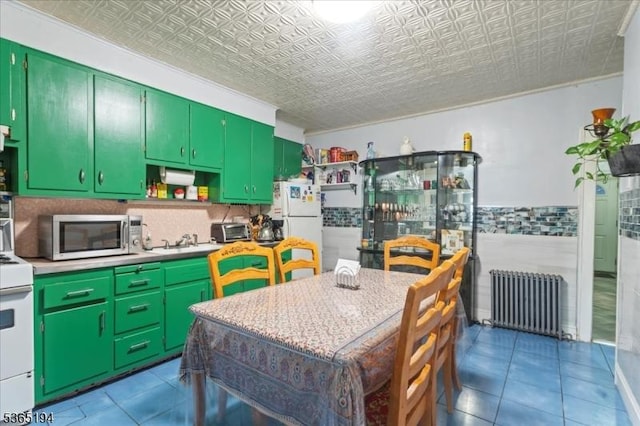 93 Garside St, Newark City, NJ 07104 - kitchen with radiator heating unit, white appliances, an ornate ceiling, tile patterned flooring, and light countertops