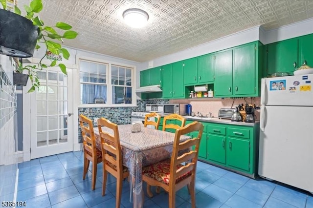 93 Garside St, Newark City, NJ 07104 - kitchen featuring freestanding refrigerator, an ornate ceiling, backsplash, under cabinet range hood, and light tile patterned floors