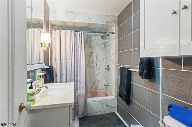 93 Garside St, Newark City, NJ 07104 - full bathroom featuring tile walls, vanity, and a combined bath / shower with marble appearance