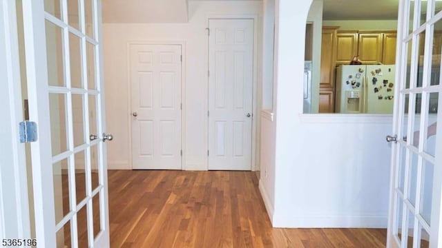 228 Windmill Ct, Lopatcong Twp, NJ 08865 - hallway featuring wood finished floors, french doors, and arched walkways