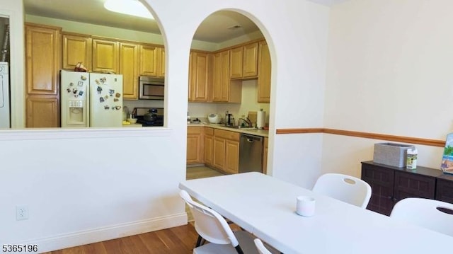 228 Windmill Ct, Lopatcong Twp, NJ 08865 - kitchen featuring stainless steel appliances, light countertops, light wood-type flooring, and arched walkways