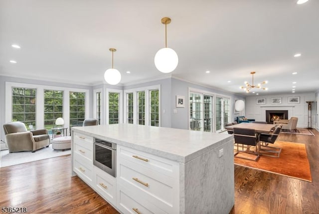 95 Green Ave, Madison Boro, NJ 07940 - kitchen featuring open floor plan, ornamental molding, dark wood finished floors, white cabinetry, and plenty of natural light