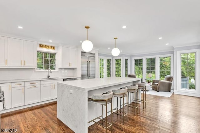 95 Green Ave, Madison Boro, NJ 07940 - kitchen featuring built in refrigerator, a center island, light countertops, dark wood-style floors, and white cabinets