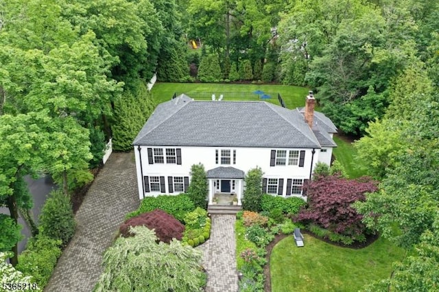 95 Green Ave, Madison Boro, NJ 07940 - view of front of property featuring a chimney, a front lawn, roof with shingles, and a wooded view
