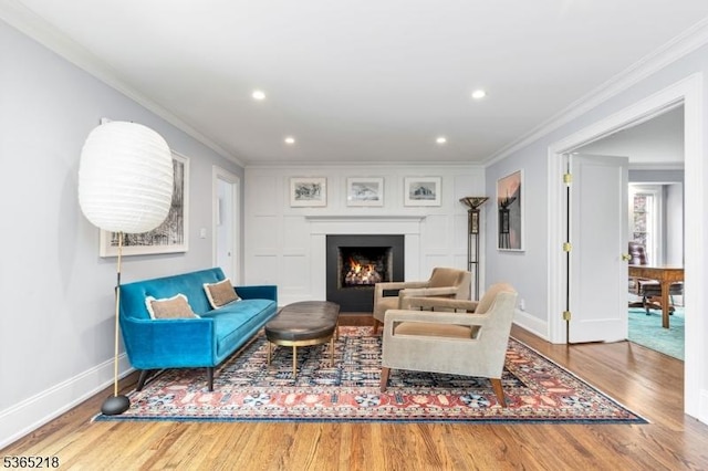 95 Green Ave, Madison Boro, NJ 07940 - living area featuring wood finished floors, crown molding, recessed lighting, and a warm lit fireplace