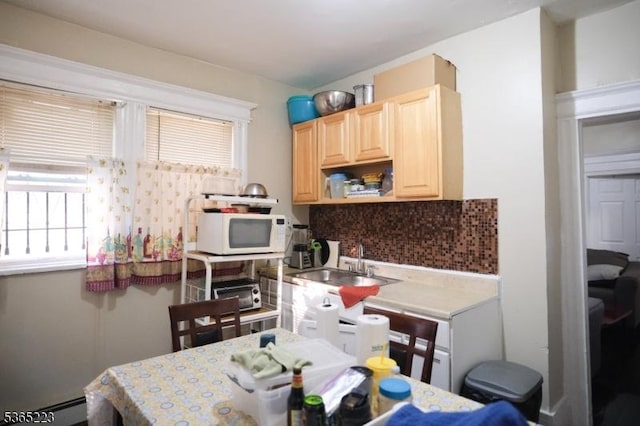 37 Grace St, Irvington Twp, NJ 07111 - kitchen with white microwave, light brown cabinets, backsplash, baseboard heating, and light countertops