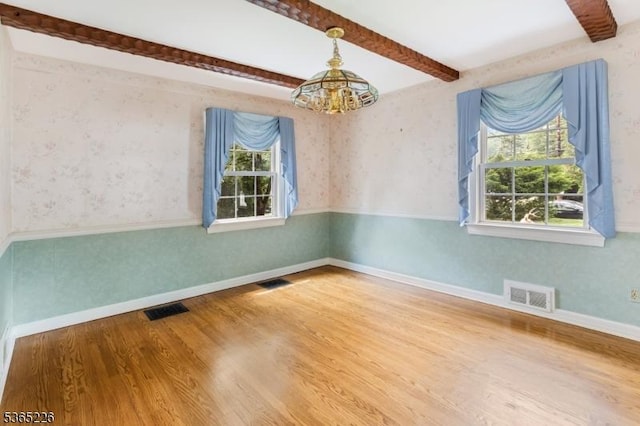 2538 Mountain Ave, Scotch Plains Twp, NJ 07076 - spare room with a chandelier, healthy amount of natural light, wood finished floors, beam ceiling, and wallpapered walls