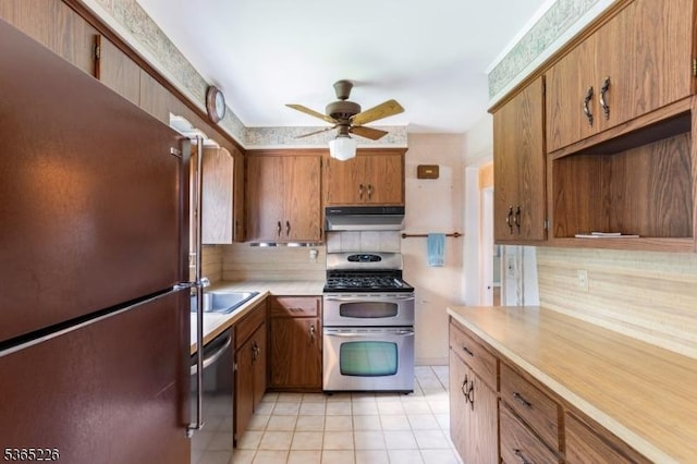 2538 Mountain Ave, Scotch Plains Twp, NJ 07076 - kitchen featuring appliances with stainless steel finishes, under cabinet range hood, ceiling fan, light countertops, and light tile patterned floors