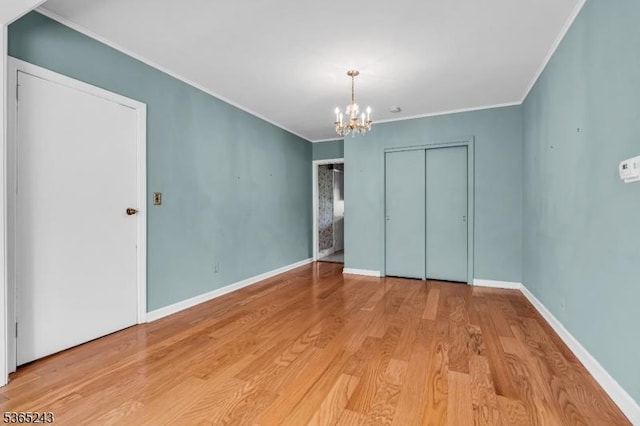 13 S St, Madison Boro, NJ 07940 - unfurnished bedroom featuring a chandelier, wood finished floors, ornamental molding, and a closet
