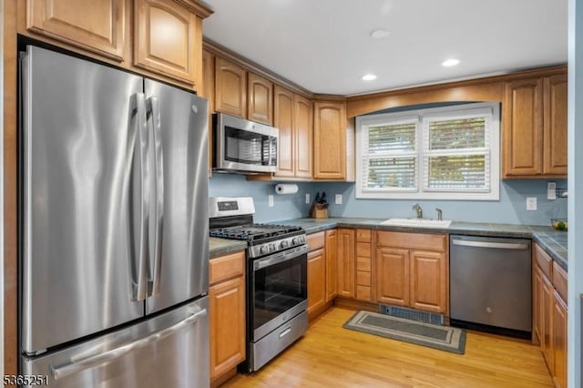 67 Riverview Ave, Lincoln Park Boro, NJ 07035 - kitchen featuring stainless steel appliances, light wood finished floors, recessed lighting, and brown cabinetry