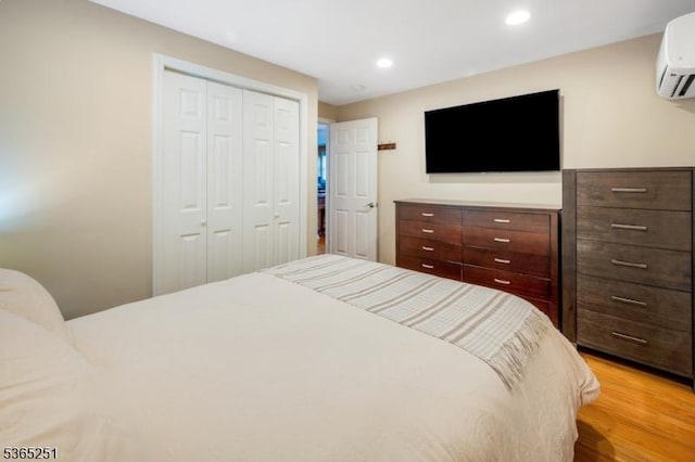 67 Riverview Ave, Lincoln Park Boro, NJ 07035 - bedroom featuring a wall unit AC, a closet, light wood finished floors, and recessed lighting