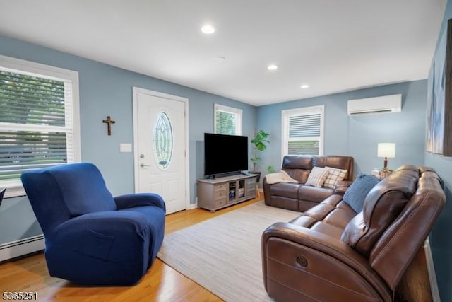 67 Riverview Ave, Lincoln Park Boro, NJ 07035 - living room with a wall mounted AC, recessed lighting, light wood-type flooring, and a baseboard heating unit