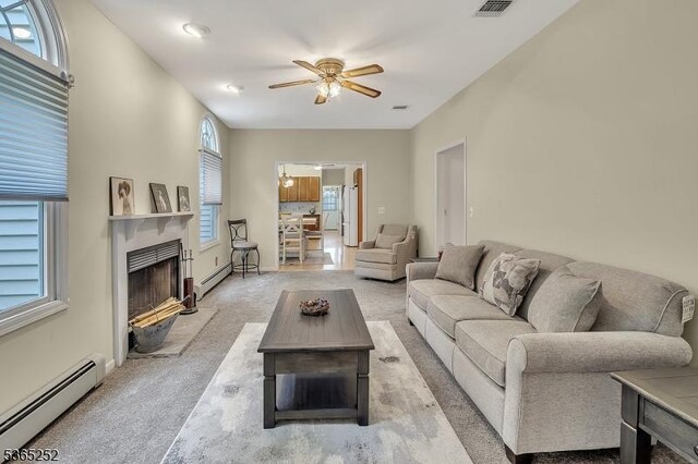 23 Estate Dr, Wantage Twp, NJ 07461 - living area with baseboard heating, ceiling fan, light carpet, and plenty of natural light