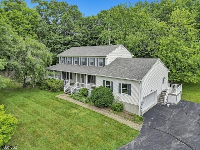 23 Estate Dr, Wantage Twp, NJ 07461 - view of front of house featuring a porch, roof with shingles, asphalt driveway, a front yard, and stairs