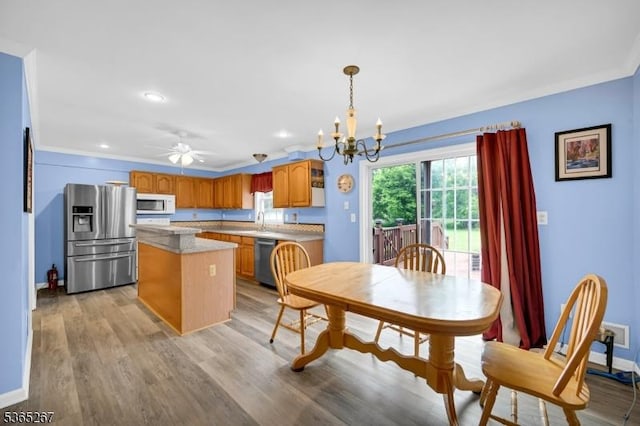 8 Dahn Dr, Sparta Twp, NJ 07871 - dining space with a chandelier, light wood-style flooring, ceiling fan, recessed lighting, and crown molding