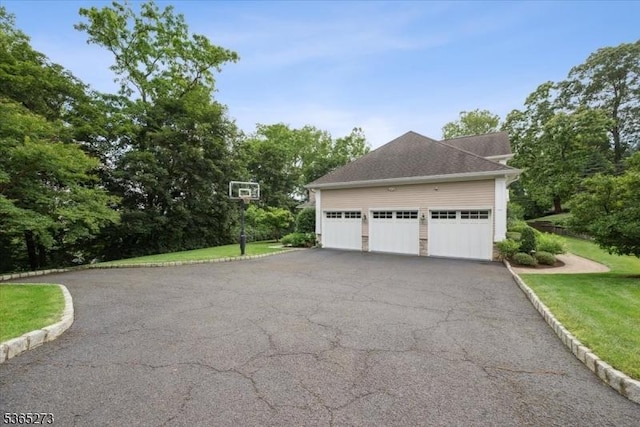 7 Sycamore Dr, Chatham Twp, NJ 07928 - view of side of property with a garage, asphalt driveway, a lawn, and view of scattered trees