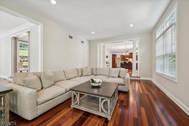 7 Sycamore Dr, Chatham Twp, NJ 07928 - living area featuring decorative columns, dark wood-type flooring, recessed lighting, a chandelier, and crown molding