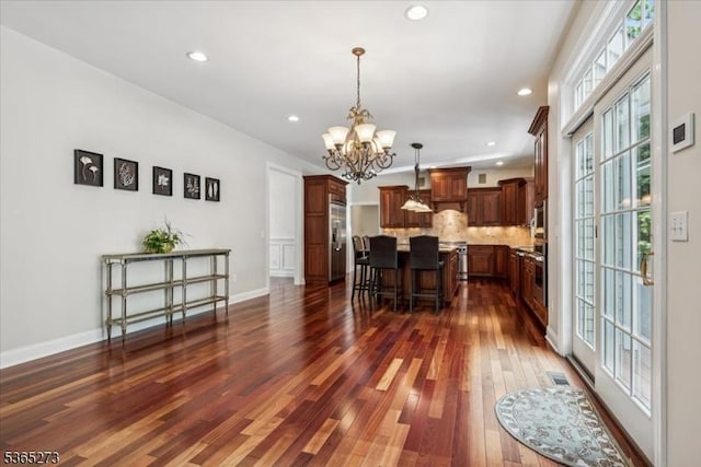 7 Sycamore Dr, Chatham Twp, NJ 07928 - kitchen with stainless steel appliances, a chandelier, a breakfast bar area, a center island, and dark wood-style floors