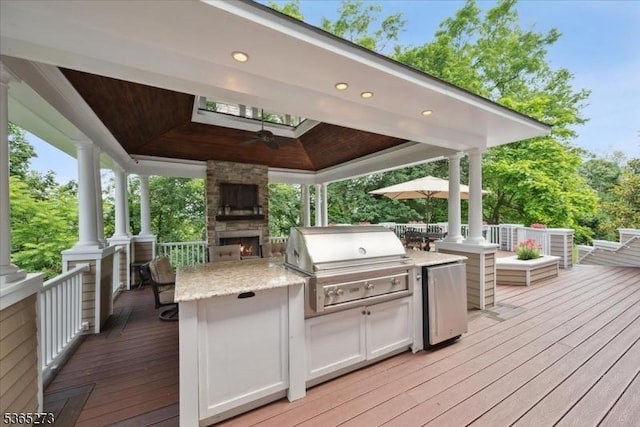 7 Sycamore Dr, Chatham Twp, NJ 07928 - wooden deck with an outdoor stone fireplace, a gazebo, exterior kitchen, and a ceiling fan