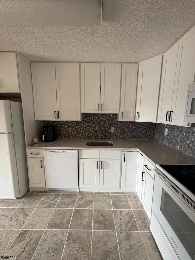 10 N Wood Ave Unit 316, Linden City, NJ 07036 - kitchen with white appliances, a textured ceiling, decorative backsplash, white cabinets, and light stone finish flooring