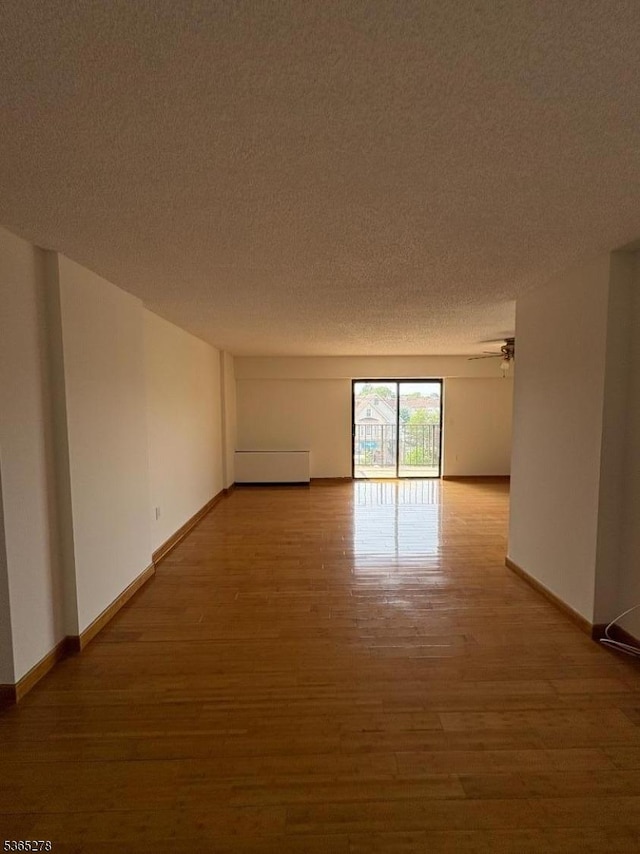 10 N Wood Ave Unit 316, Linden City, NJ 07036 - spare room featuring wood finished floors and a textured ceiling