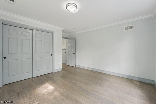 126 Cooney Ave, Hamilton Twp, NJ 08619 - unfurnished bedroom with wood finished floors, crown molding, and a closet