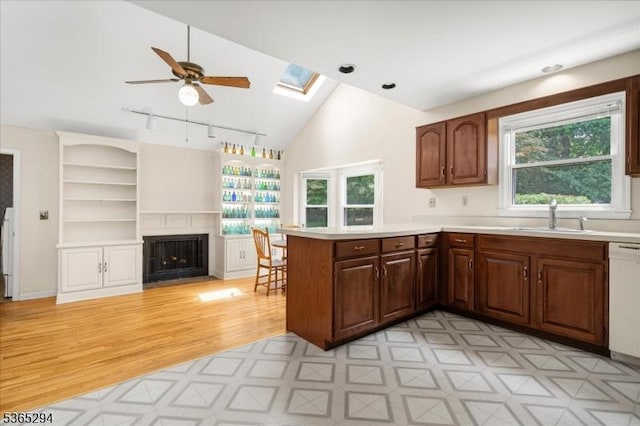 10 Duke Ct, Franklin Twp, NJ 08867 - kitchen with a peninsula, healthy amount of natural light, a skylight, light countertops, and vaulted ceiling