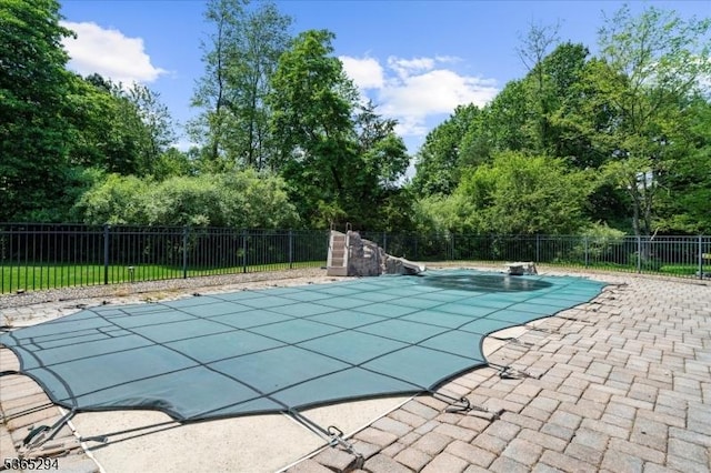 10 Duke Ct, Franklin Twp, NJ 08867 - view of pool featuring a patio area, a water slide, and view of scattered trees