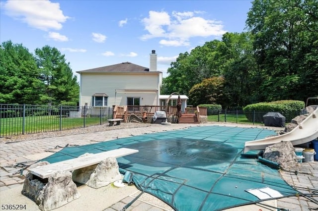 10 Duke Ct, Franklin Twp, NJ 08867 - view of swimming pool featuring a water slide, a deck, and a diving board