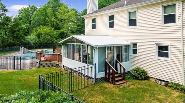 10 Duke Ct, Franklin Twp, NJ 08867 - rear view of property featuring a sunroom, a chimney, a community pool, a fenced backyard, and entry steps