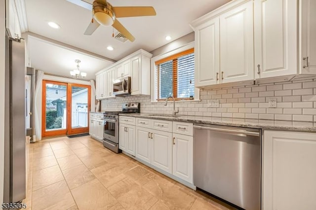 103 Cedar St, Nutley Twp, NJ 07110 - kitchen with stainless steel appliances, white cabinets, decorative backsplash, light stone countertops, and a ceiling fan