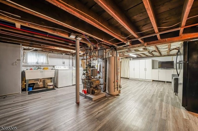 103 Cedar St, Nutley Twp, NJ 07110 - basement with washing machine and dryer, gas water heater, wood finished floors, and a heating unit