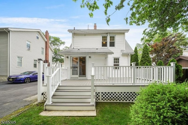 103 Cedar St, Nutley Twp, NJ 07110 - back of property with a wooden deck, a shingled roof, and a chimney