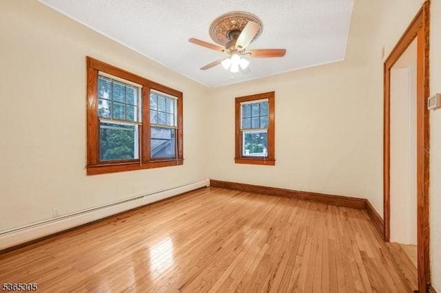 103 Cedar St, Nutley Twp, NJ 07110 - spare room with a baseboard radiator, a ceiling fan, and light wood-type flooring