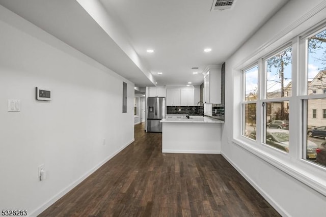 613 S 18th St, Newark City, NJ 07103 - kitchen with stainless steel fridge, dark wood-style flooring, a peninsula, light countertops, and recessed lighting