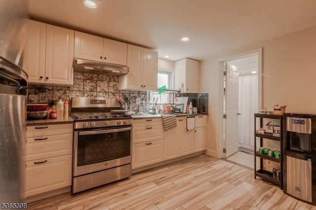 104 W Emerson Ave, Rahway City, NJ 07065 - kitchen with stainless steel range with gas stovetop, under cabinet range hood, decorative backsplash, recessed lighting, and white cabinets