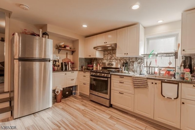 104 W Emerson Ave, Rahway City, NJ 07065 - kitchen with stainless steel appliances, under cabinet range hood, tasteful backsplash, light wood finished floors, and recessed lighting